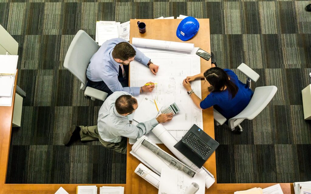 MCA settlement negotiation meeting across small conference table