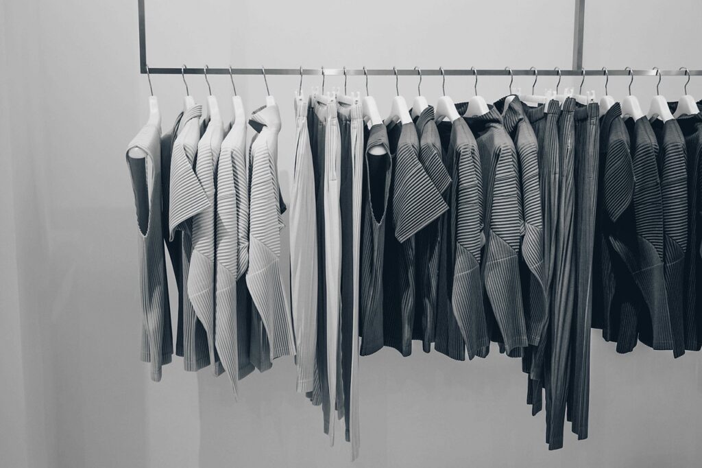 Small boutique retail store interior with clothing racks and morning light