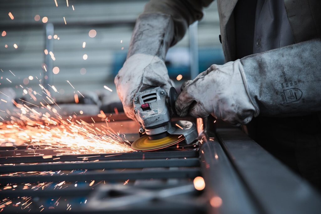 Small manufacturing shop production floor with metal parts and machinery