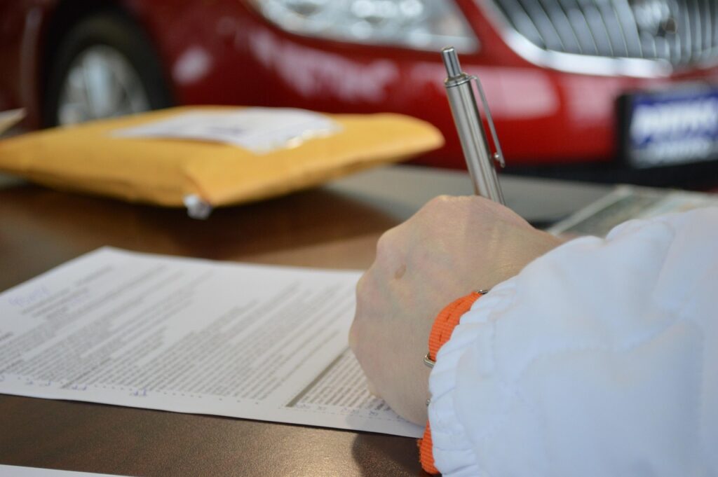 An MCA contract on a desk next to a pen