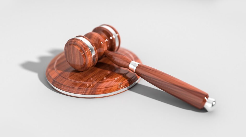 Gavel and business contracts on a desk representing court judgment in MCA enforcement