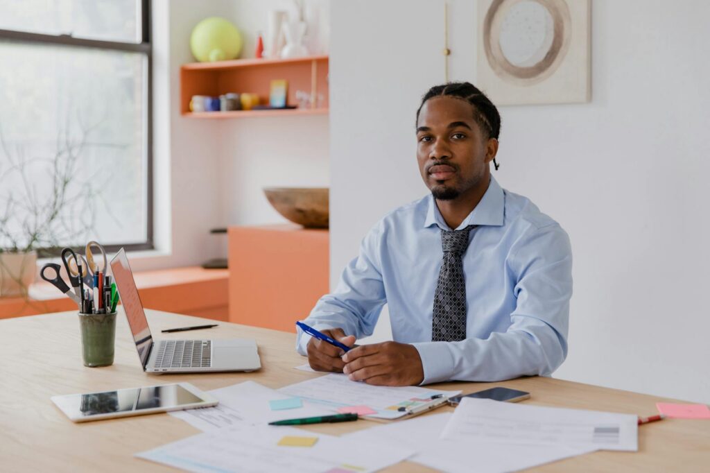 A small business owner drafting a hardship letter at a kitchen table
