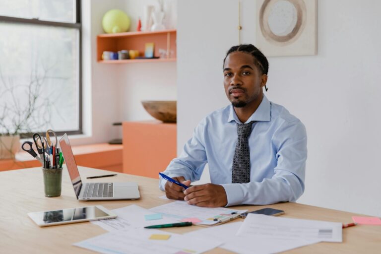 A small business owner drafting a hardship letter at a kitchen table