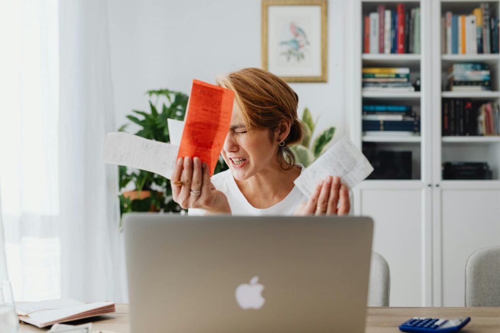 Business owner reviewing daily MCA debits on laptop screen