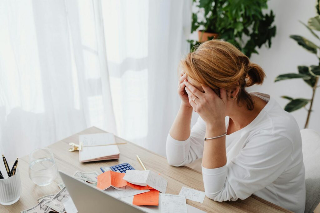 Owner reviewing a stack of bills and bank statements