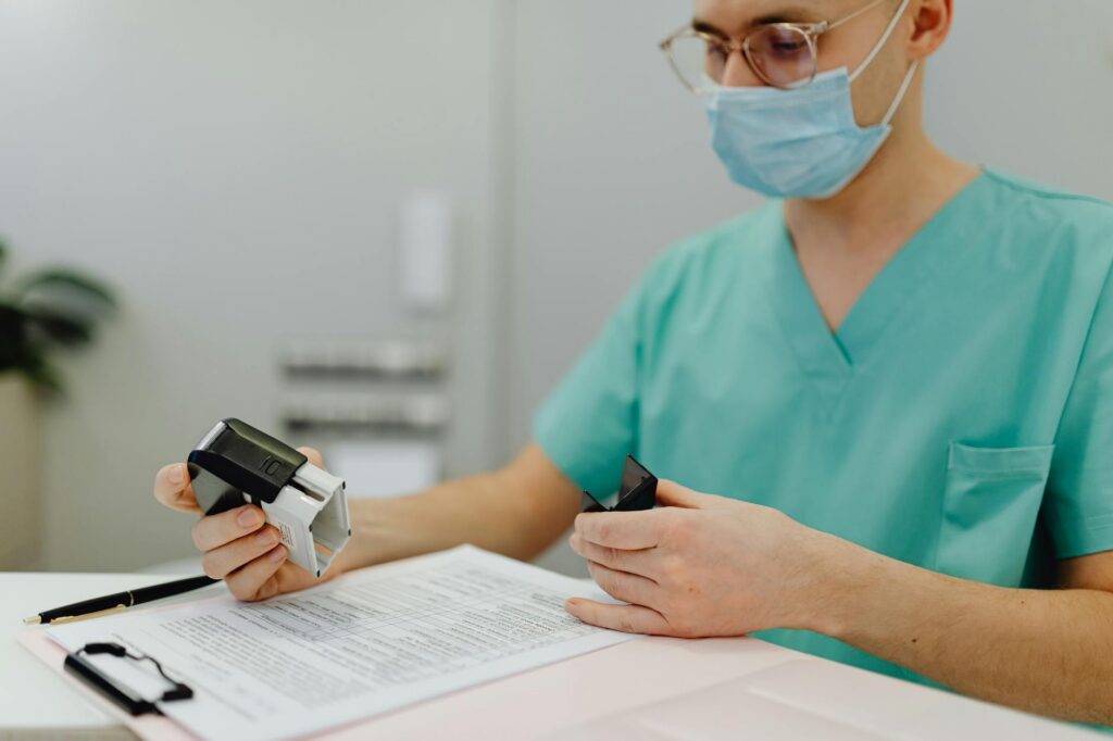 Healthcare practice owner reviewing MCA debt paperwork at clinic desk