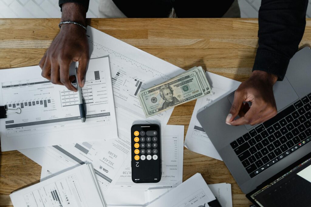 Multiple financial documents and bills representing MCA stacking debt for an e-commerce business