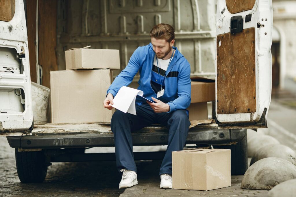 HVAC contractor reviewing MCA debt paperwork in work van