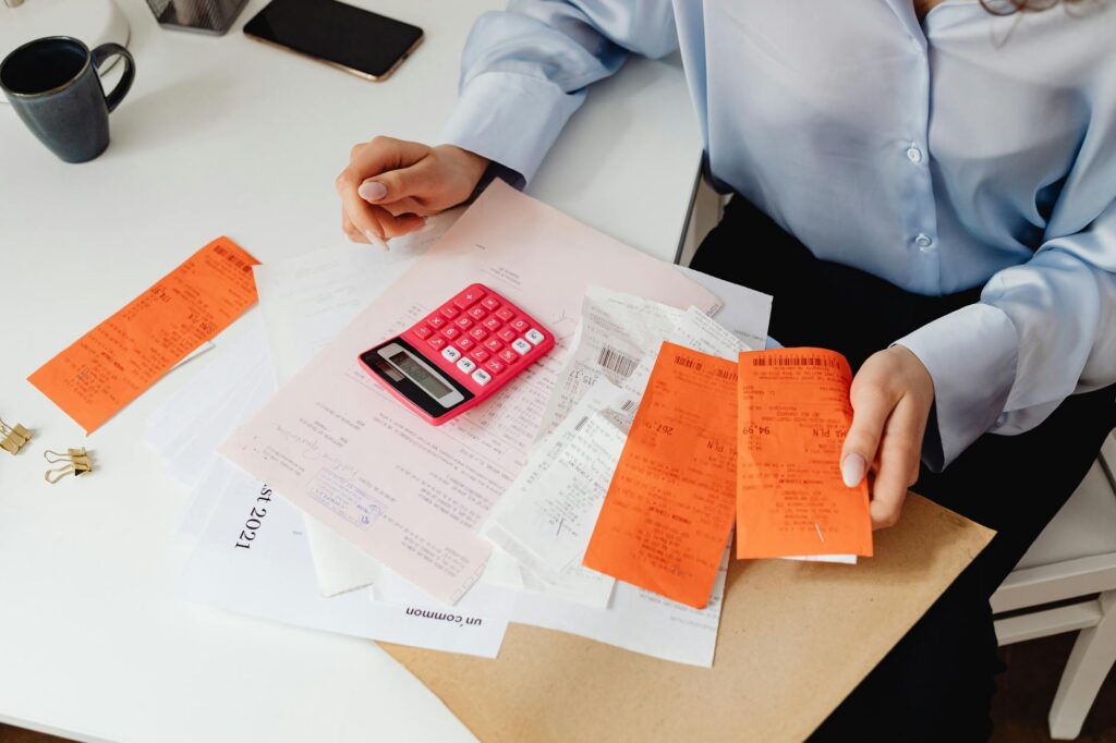 Business owner on phone discussing MCA options with specialist while reviewing documents