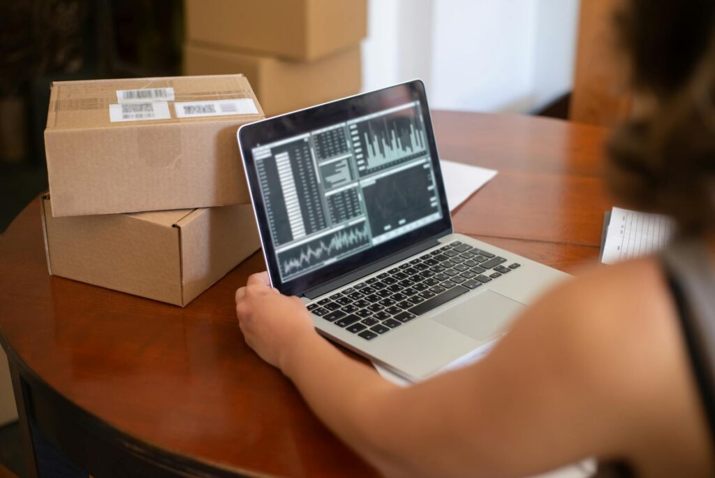 E-commerce business owner looking anxiously at laptop reviewing payment notifications