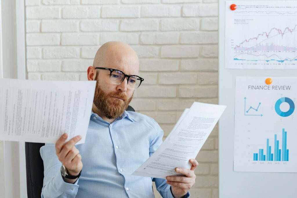 Business owner reviewing cleared UCC liens after successful MCA debt settlement