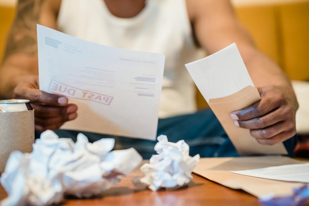 Small business owner overwhelmed by stacked MCA debt reviewing bank statements