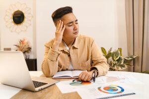 Construction business owner reviewing MCA debt paperwork at job site office