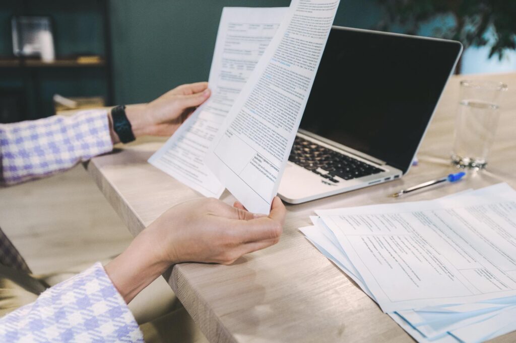 Business owner reviewing MCA contract fine print and personal guarantee terms