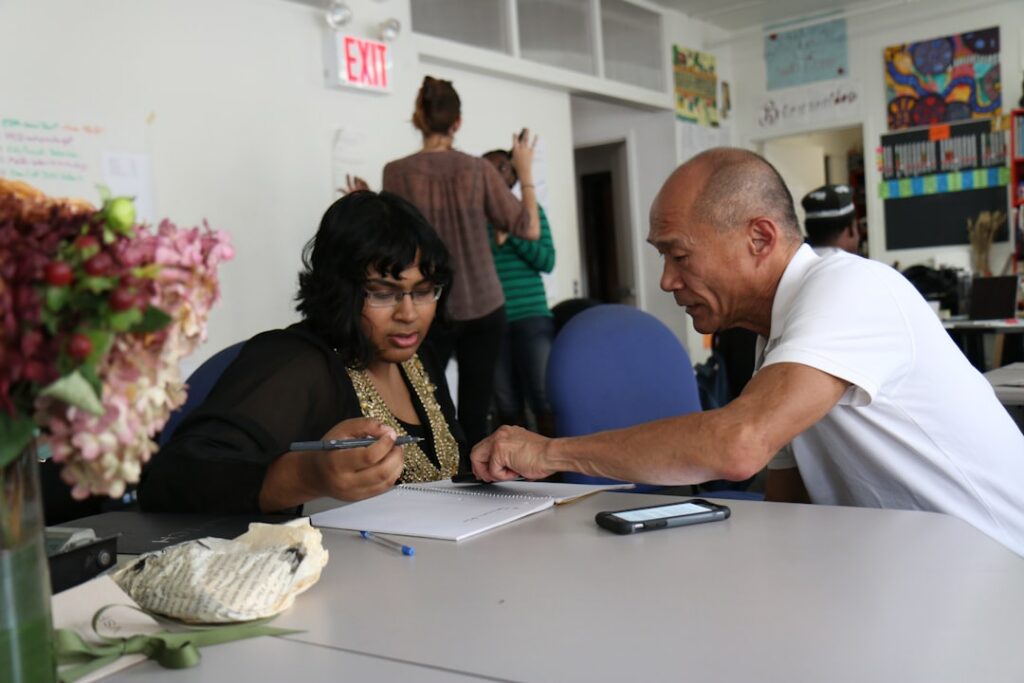Small business owner at a debt negotiation meeting reviewing a resolution agreement