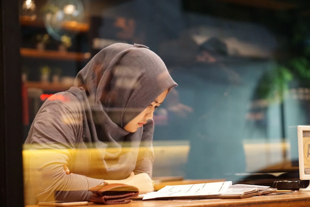 Small business owner reviewing MCA financial documents under stress
