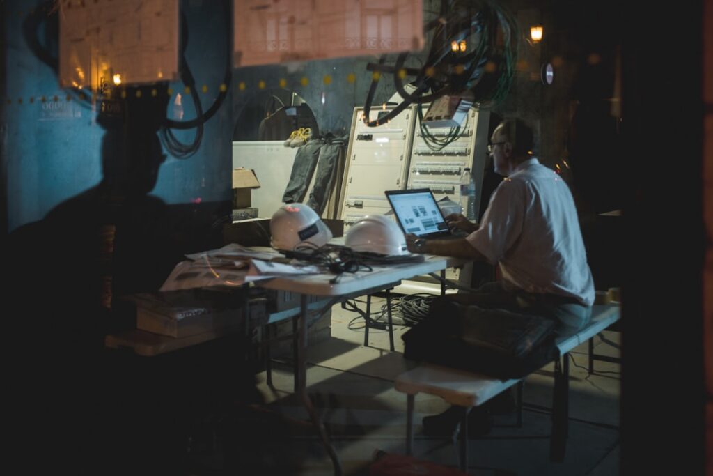 Small business owner reviewing concerning financial reports late at night