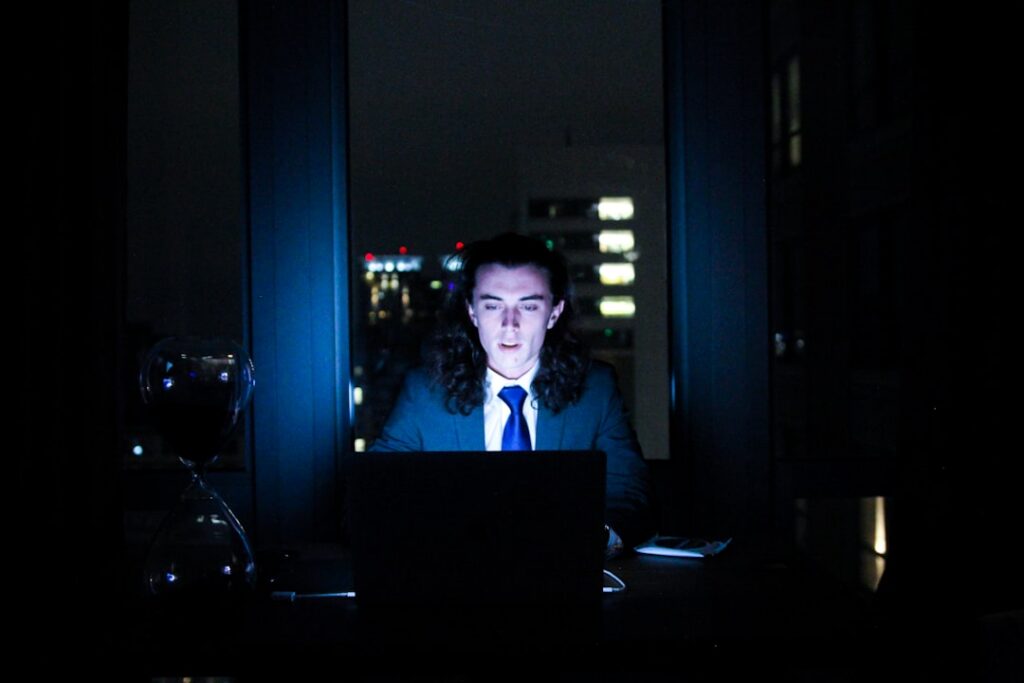 Small business owner stressed reviewing finances at night