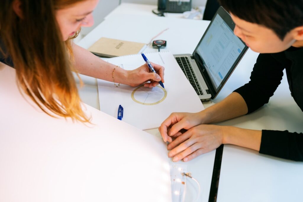 Two parties signing a formal settlement agreement at a desk