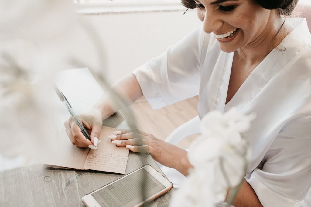 Small business owner smiling with relief at a desk with papers showing resolved financial situation
