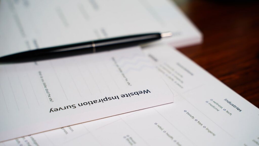 SBA loan application paperwork and pen laid out on an office desk