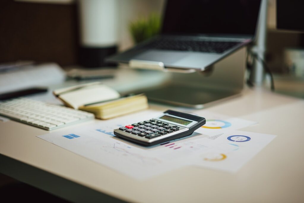 Business financial documents, credit report, and tax returns laid out for a loan review