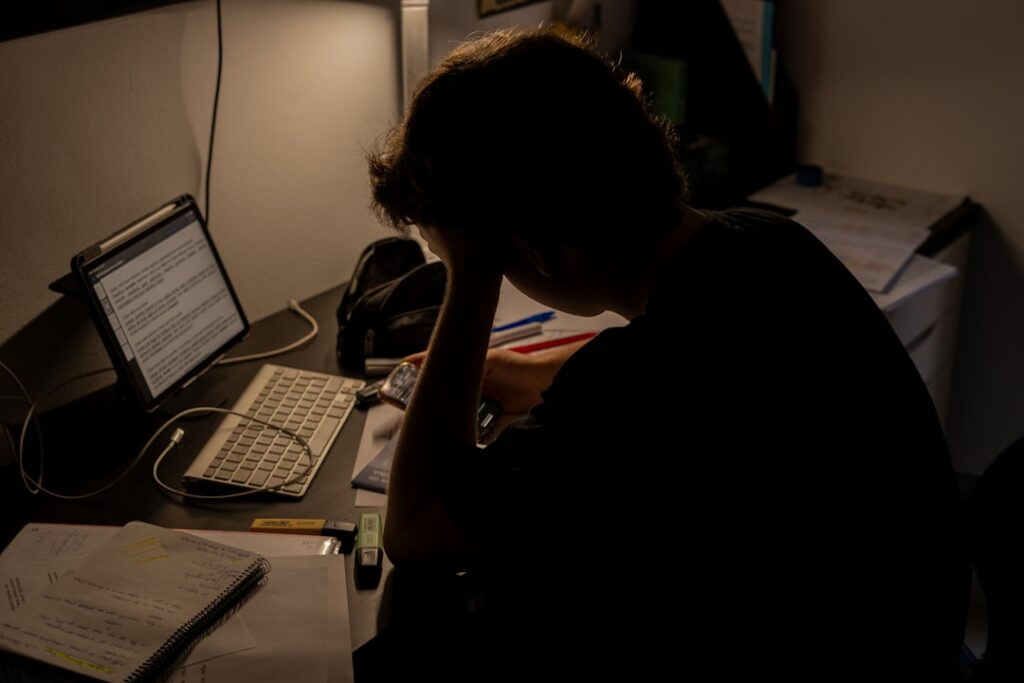 Small business contractor reviewing overdue financial notices and business debt documents