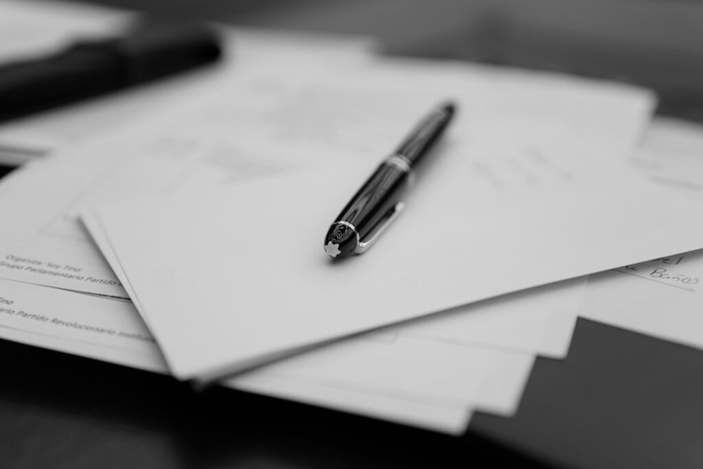 MCA contract documents with personal guarantee clause and pen on desk