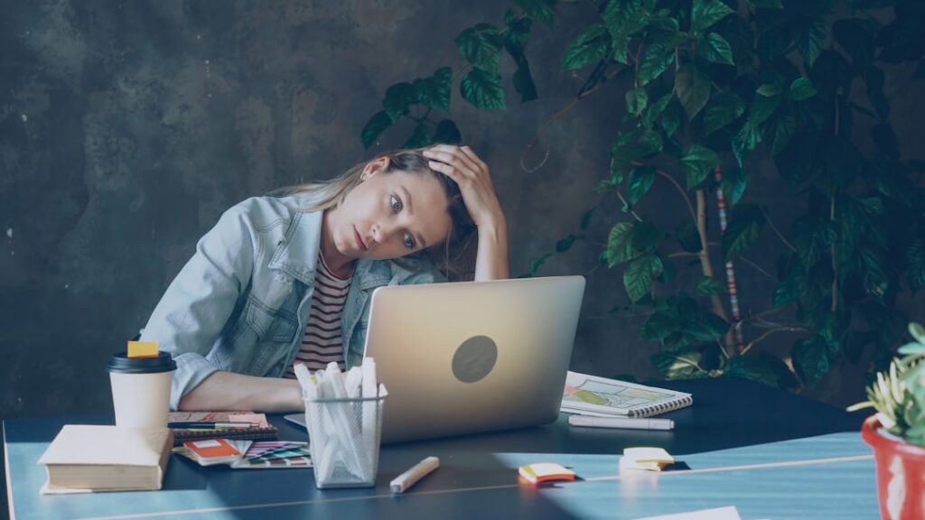 Business owner stressed at computer managing payroll and cash flow with MCA lockbox