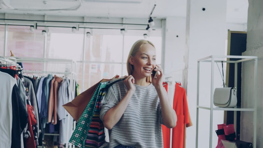 Retail boutique owner on phone consulting MCA relief specialist looking relieved