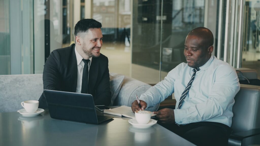 Business negotiation across a desk representing MCA debt settlement discussions pre-judgment