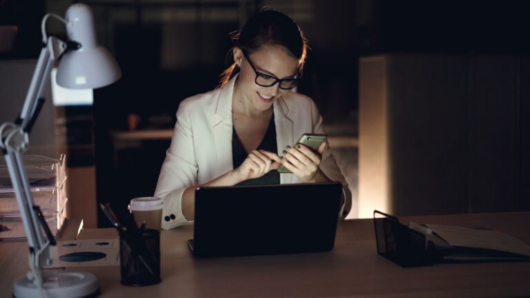Small business owner reviewing MCA payment statements and bank account balance