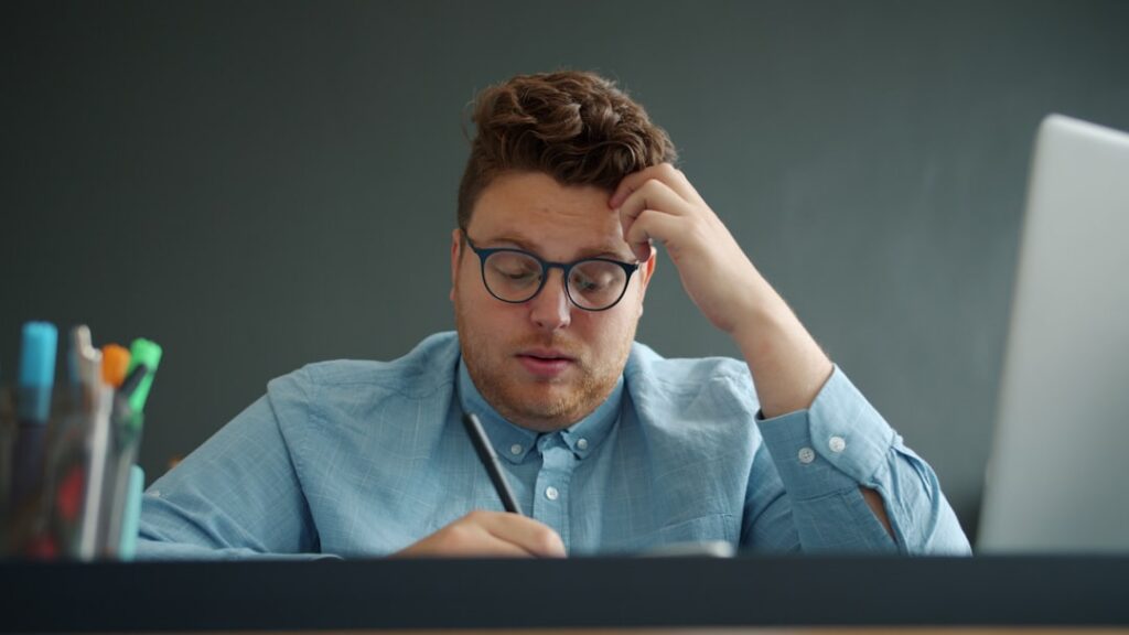 Small business owner reading a settlement offer document at their desk