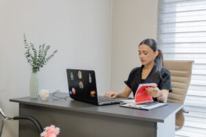 Landscaping business owner reviewing MCA debt paperwork at office desk