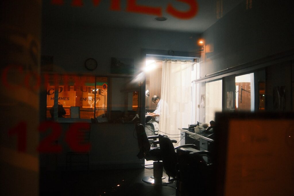 Empty salon chairs and styling stations in a small salon early in the morning