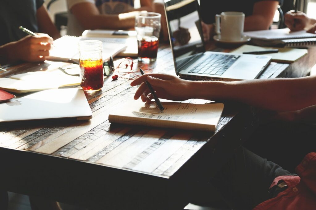 Business owner and advisor reviewing MCA debt restructuring and settlement options
