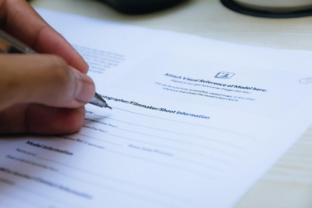 Business owner signing an MCA settlement agreement at a small business office