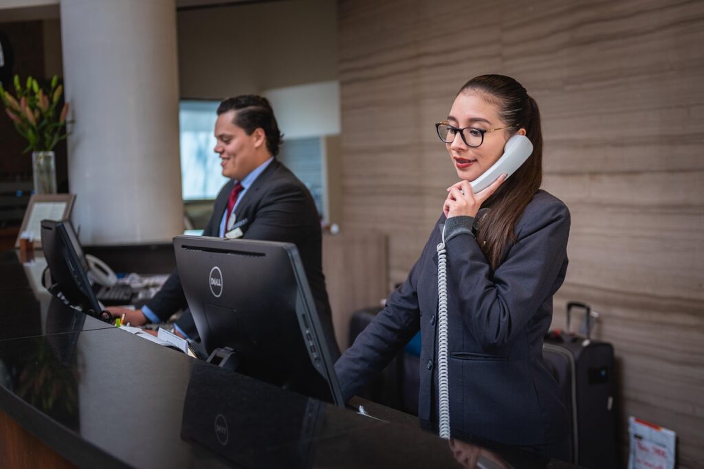 Small business owner making a proactive call to an MCA relief specialist in June before summer cash flow problems worsen