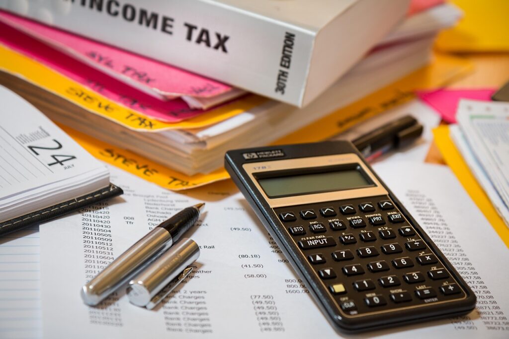 IRS estimated tax form and calculator on a small business owner's desk