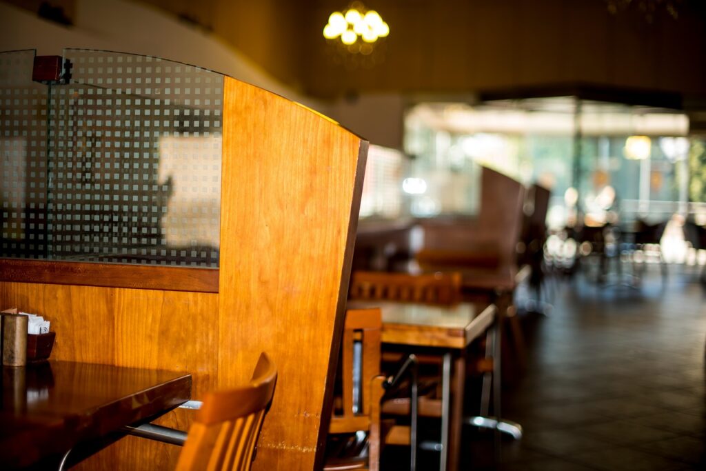 Empty restaurant during summer slow season illustrating seasonal revenue drops and MCA payment pressure