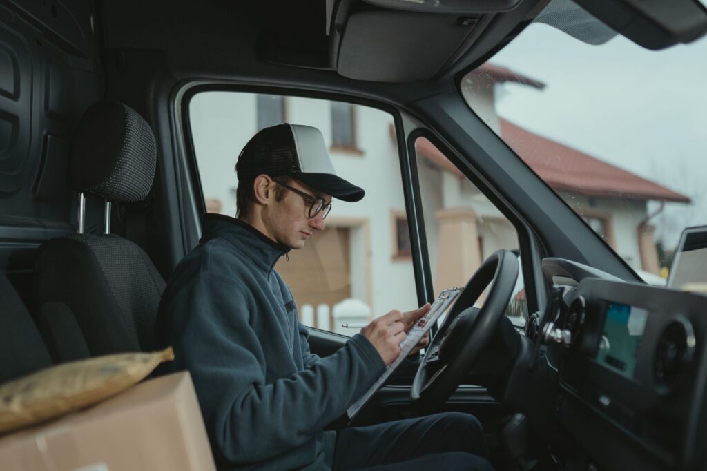 Freight trucking owner reviewing invoices and factoring paperwork at dispatch