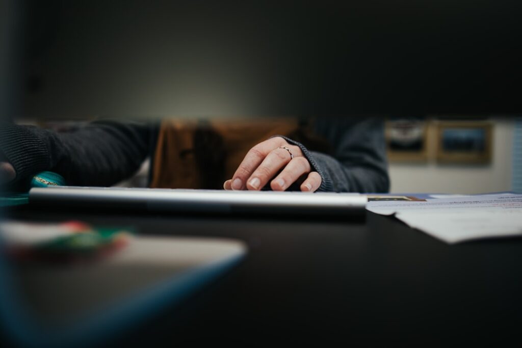 Business owner reviewing MCA advance documents late at night under financial pressure