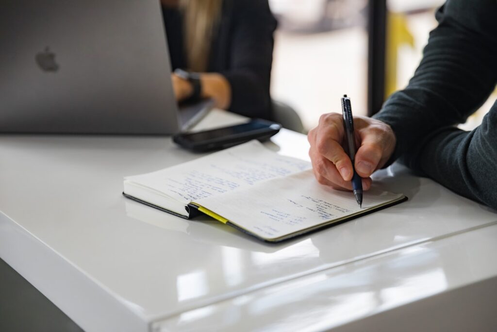 Business owner signing MCA settlement documents at desk