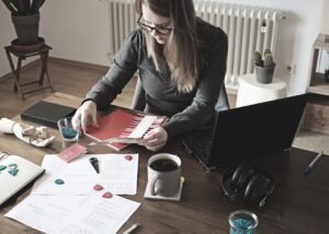 Small business owner reviewing tax documents and MCA bank statements at their desk