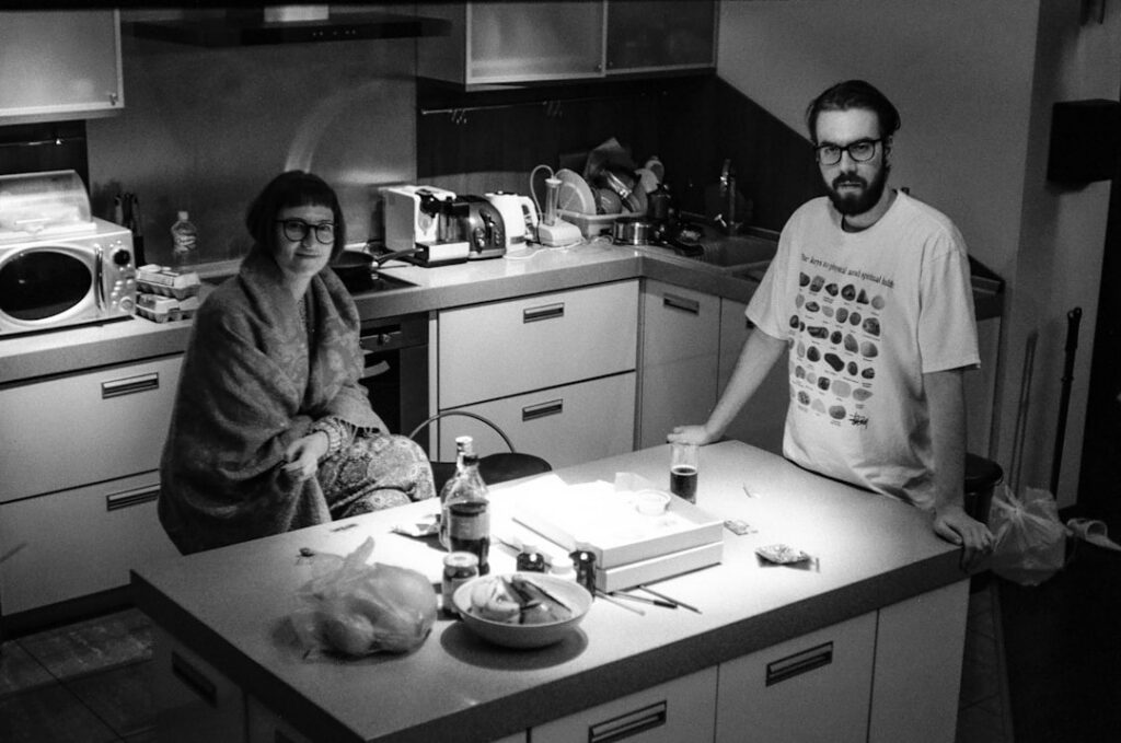 Business owner reviewing MCA payment notices at kitchen table