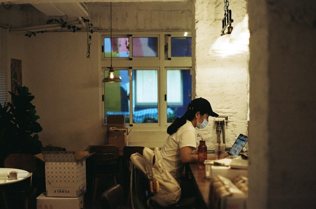 Small business owner reviewing multiple MCA contracts at desk late at night