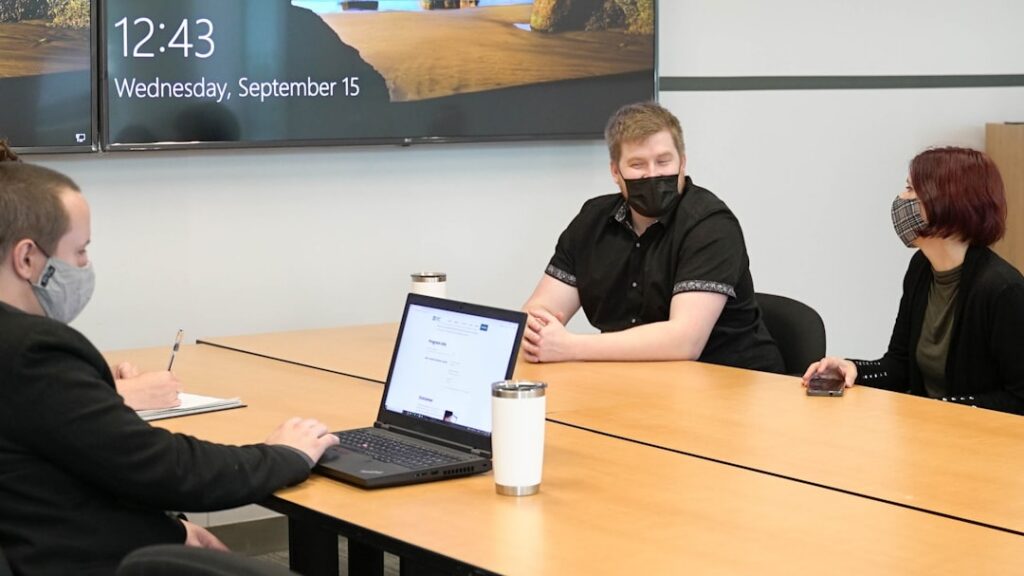 Small business owner consulting with financial advisor at conference table