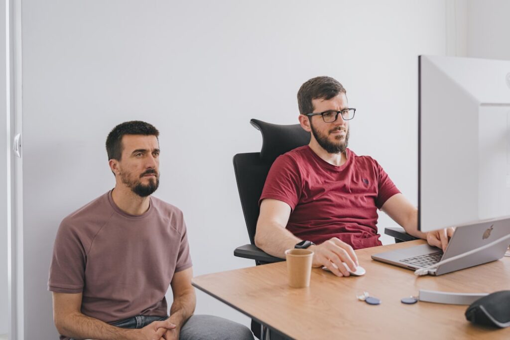 Business owner reviewing financial documents with a broker at a small office