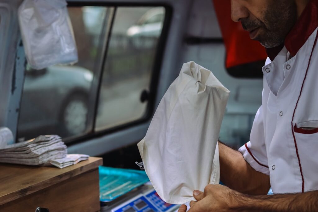 Trucking owner-operator reviewing multiple MCA advance documents at office desk