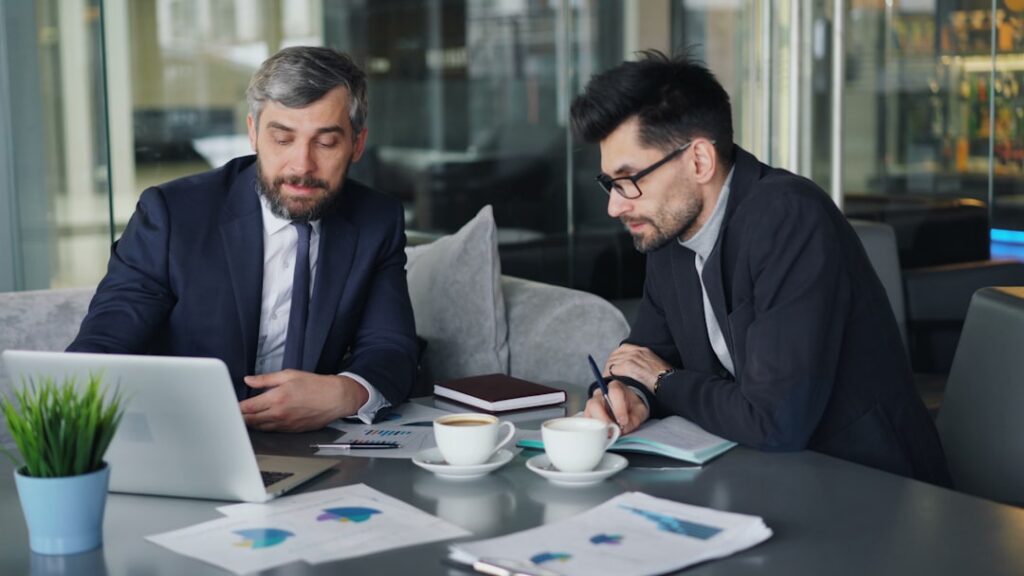 Accountant reviewing business financial records during acquisition due diligence